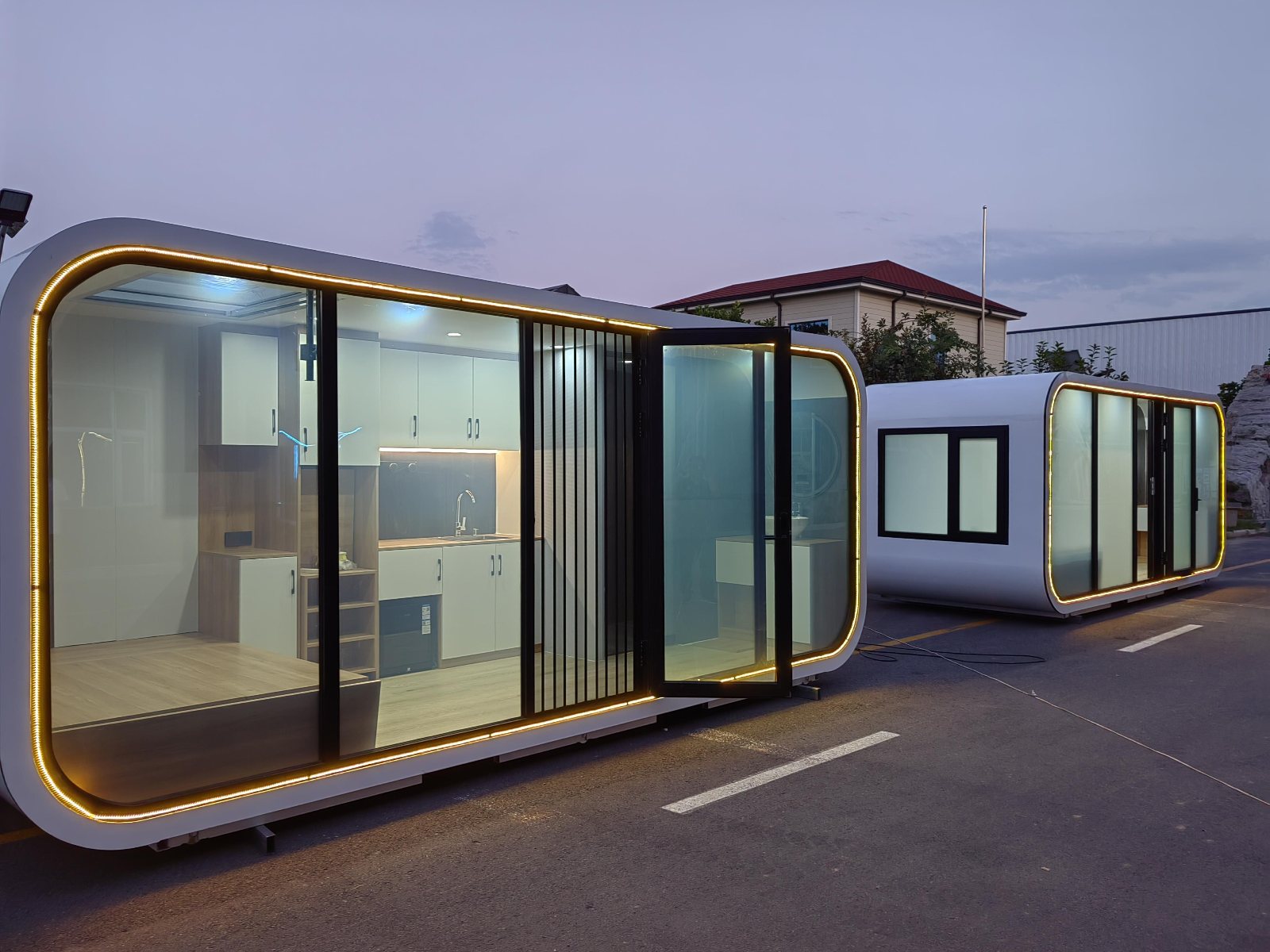 Two Home Pods in the factory yard at dusk