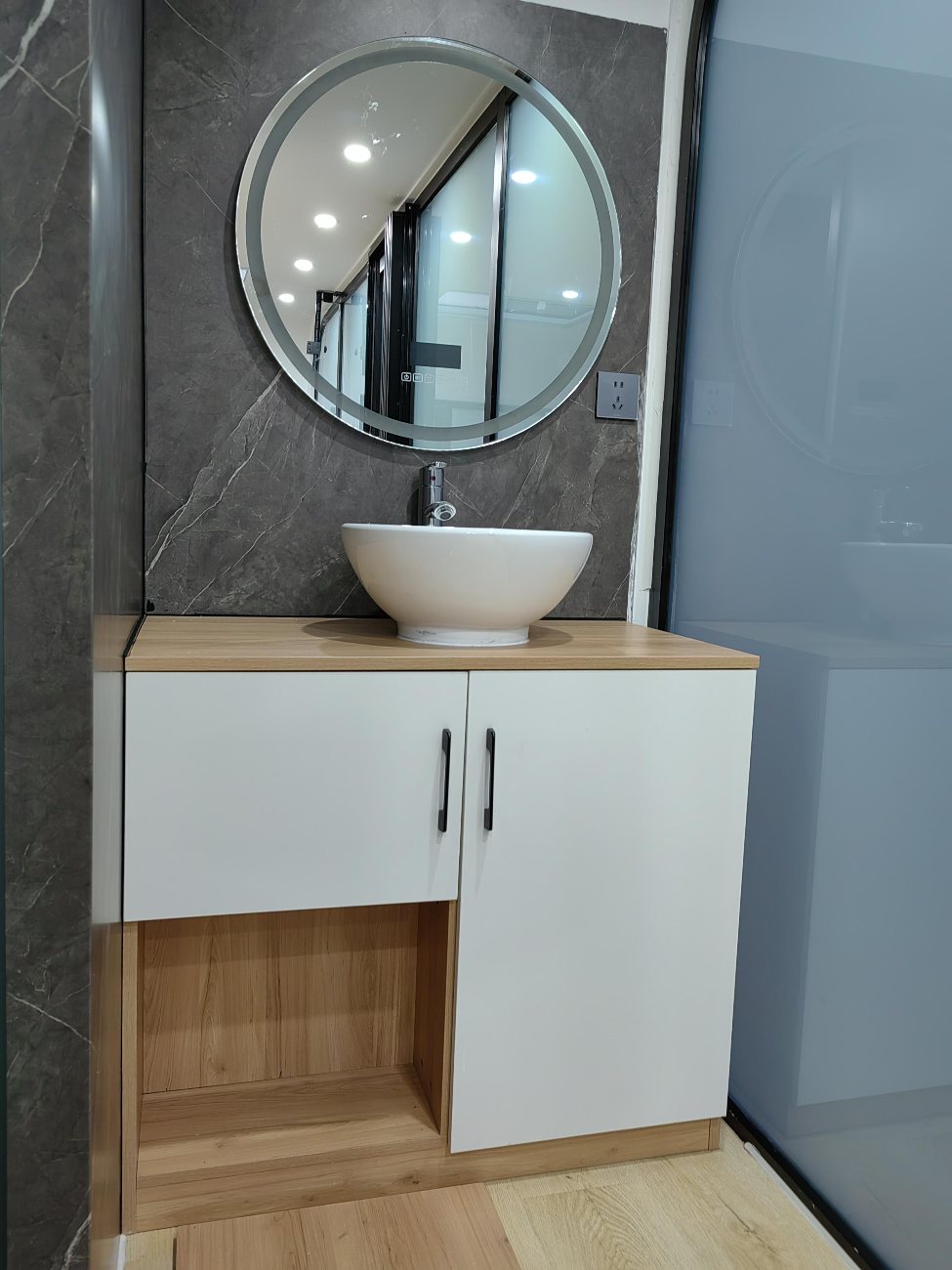 Interior: bathroom with round smart mirror